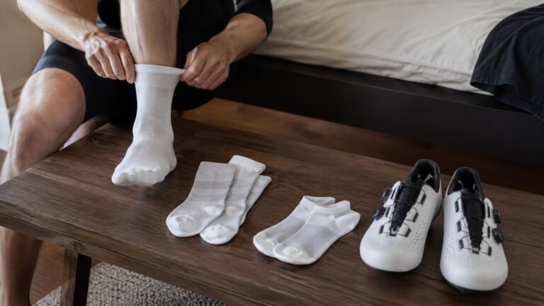 Calcetines técnicos de ciclismo preparados con zapatillas junto a una bicicleta